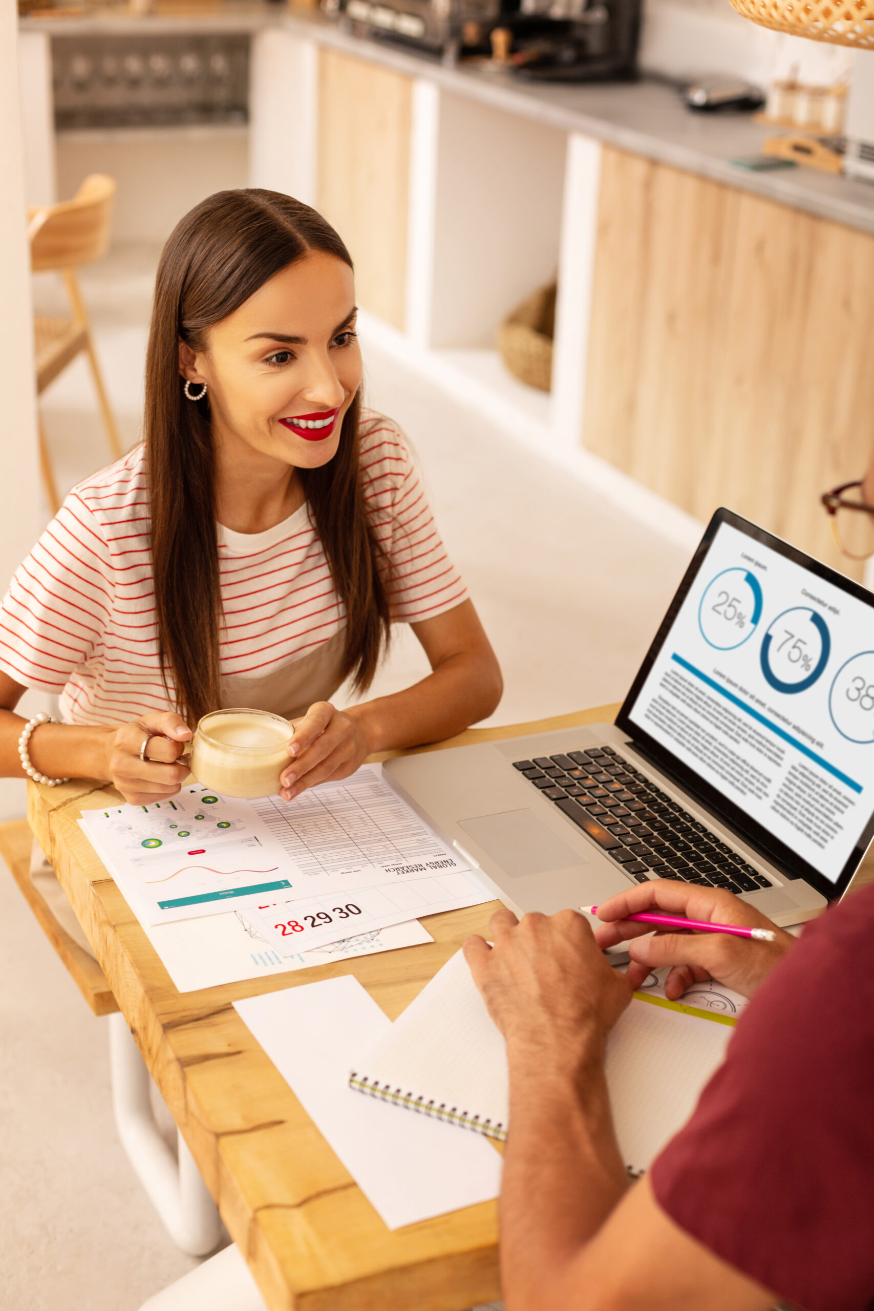 Wife drinking cappuccino and listening to husband while opening cafeteria